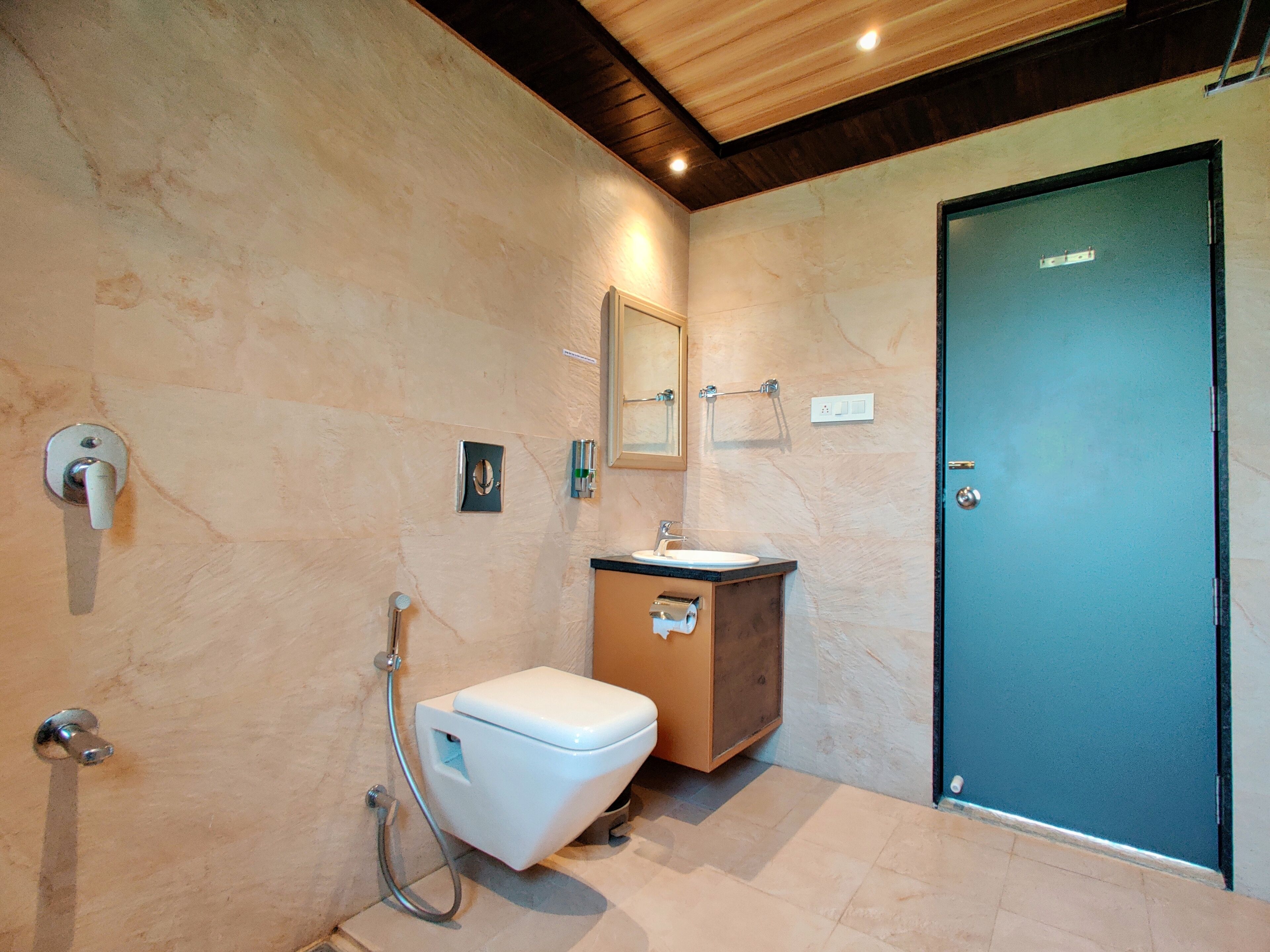 A bathroom with a toilet, sink, and shower.