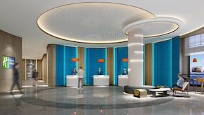 A modern hotel lobby with a central reception desk, seating areas, and a large column. - Holiday Inn Express Dandong City Center (Dandong)