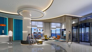 A modern lobby with a central column, seating areas, and large windows offering views. - Holiday Inn Express Dandong City Center (Dandong)
