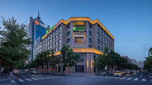 A multi-story hotel with a prominent entrance, large windows, and a modern architectural design.