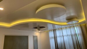 A modern ceiling with recessed lighting and a circular design element. - Hotel Blue Waves (Port Blair)