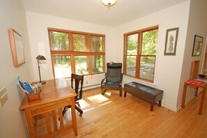 A room with a wooden table, two chairs, a bench, and large windows with blinds. - Dune Path -  with Waterfront! (Empire)