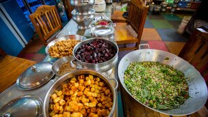 A buffet table with various dishes including cubed potatoes, beets, and a salad. - Kranti Yoga Tradition (Canacona)