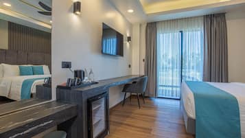 A hotel room with a bed, a desk with a chair, a television, and a balcony with curtains.