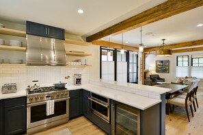 Enjoy cooking in this well-equipped kitchen with a central island, stainless steel range, and ovens.