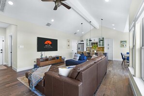 Relax in this stylish living area with a sofa, accent chair, and dining table.