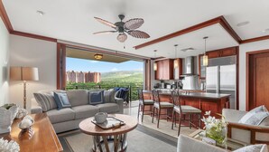 A modern living room with a sofa, coffee table, and dining area.