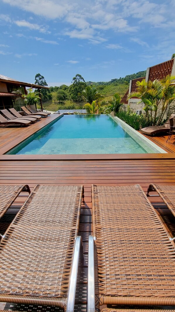 Outdoor pool, open 9:00 AM to 10:00 PM, pool umbrellas, pool loungers