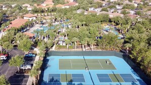 A residential area with houses, a swimming pool, and a tennis court. - EPIC VALUE! Private Pool Oasis! Water Slide! Close 2 Disney! 5488 (Davenport)