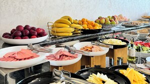 A buffet with various food items including fruits, cheeses, and meats. - Garnet Mir Hotel (Tashkent)