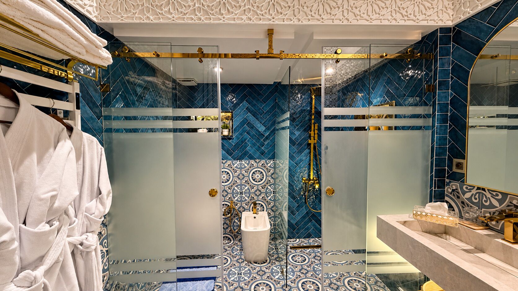 A luxurious bathroom with a glass-enclosed shower, a marble vanity, and a robe rack.