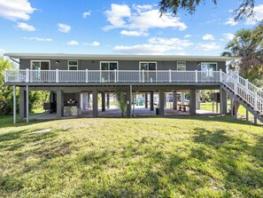 A two-story building with a covered patio area and a staircase leading to the upper level. - Luxury place - 23019 in Port Charlotte , one block to the Bayfront Park/Harbor (Port Charlotte)