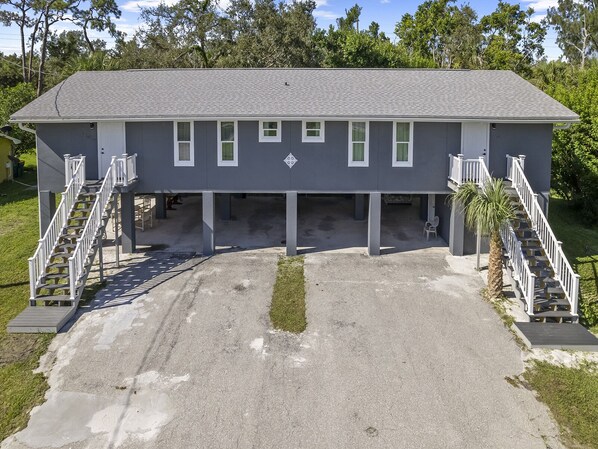 A two-story house with a garage, a covered driveway, and a small patio area. - Luxury place - 23019 in Port Charlotte , one block to the Bayfront Park/Harbor (Port Charlotte)
