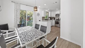 A modern kitchen with white cabinets, stainless steel appliances, and a large island. - Luxury place - 23019 in Port Charlotte , one block to the Bayfront Park/Harbor (Port Charlotte)