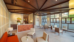 A spacious lobby with a wooden ceiling, a reception desk, and several seating areas. - Cozy An Boutique Hotel Hoian (Da Nang)
