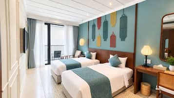 A hotel room with two beds, a TV, a bedside table with a lamp, a mirror, and a view of the balcony.
