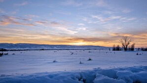 A snowy landscape with a clear sky and distant mountains. - Spacious 5BR Mountain Retreat near Grand Targhee (Driggs)
