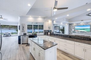 Enjoy cooking in this well-lit kitchen with a large island and TV.