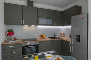 Enjoy cooking in this well-equipped kitchen with an oven, microwave, and sink.