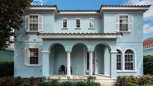 A light blue two-story house with white shutters, a covered porch with columns, and a number "1223" on the facade. - GUARDIANS and Mickey Themed! Stunning! Reunion Resort! (Reunion)