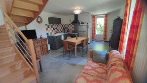 A compact living space with a kitchen, dining area, and a sofa. - LA Chaira - Neufmanil (NEUFMANIL)