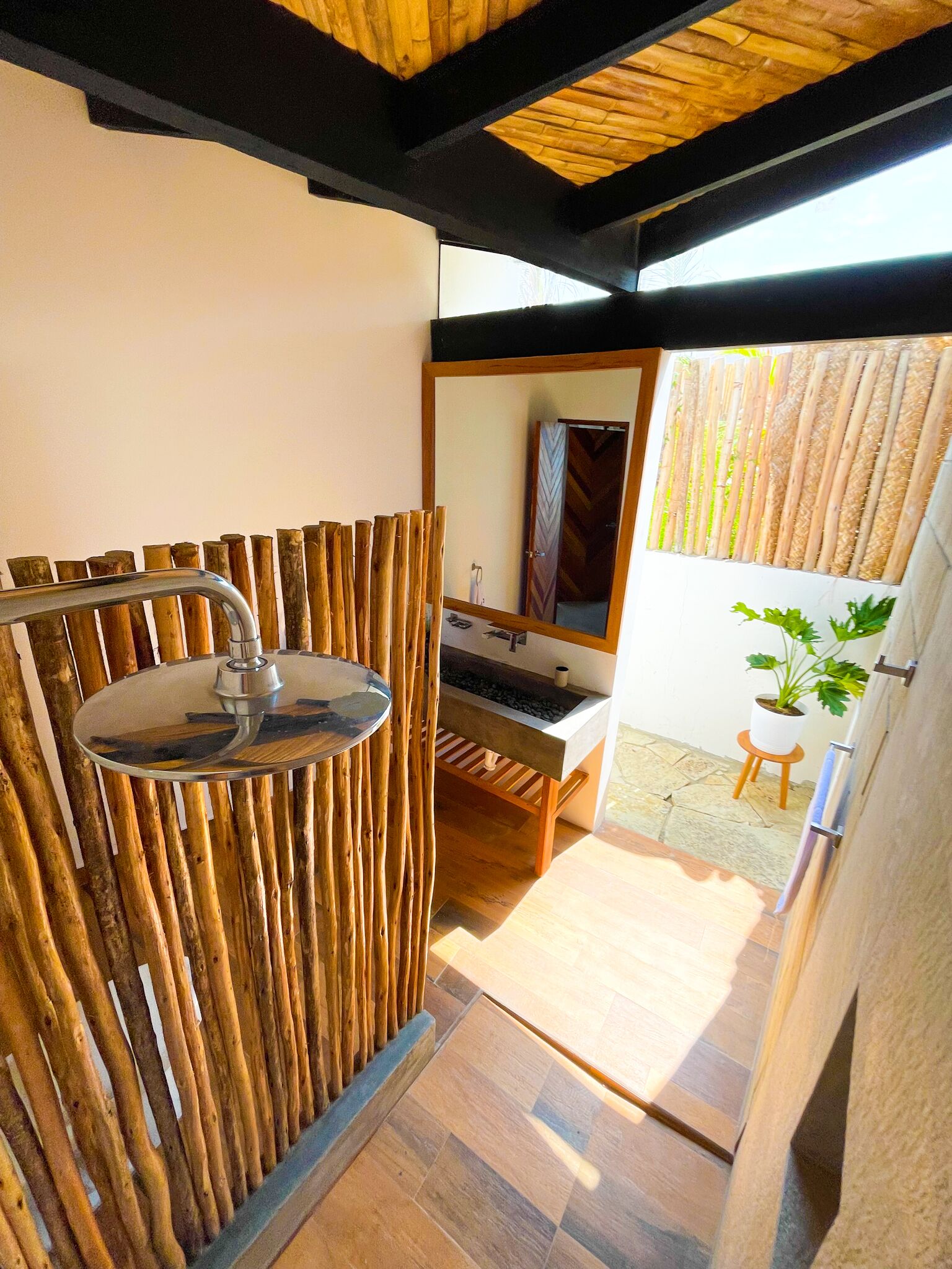 A bathroom with a wooden wall, a sink, and a mirror.