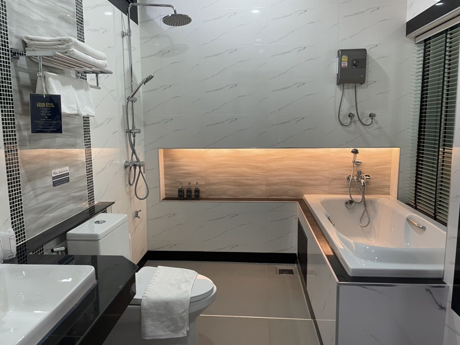 A modern bathroom with a shower, toilet, and bathtub.