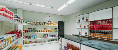 A grocery store with shelves stocked with various food items and beverages.