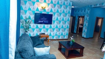 Comfort Apartment | Living area | 32-inch flat-screen TV with satellite channels