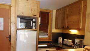 A compact kitchen with a microwave, toaster, and sink. - 3-Room Apartment · Ski-In/Ski-Out · Balcony · 7 ppl (Belle Plagne)