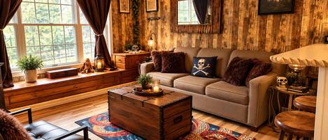 A cozy living room with a sofa, a wooden chest, and a patterned rug.