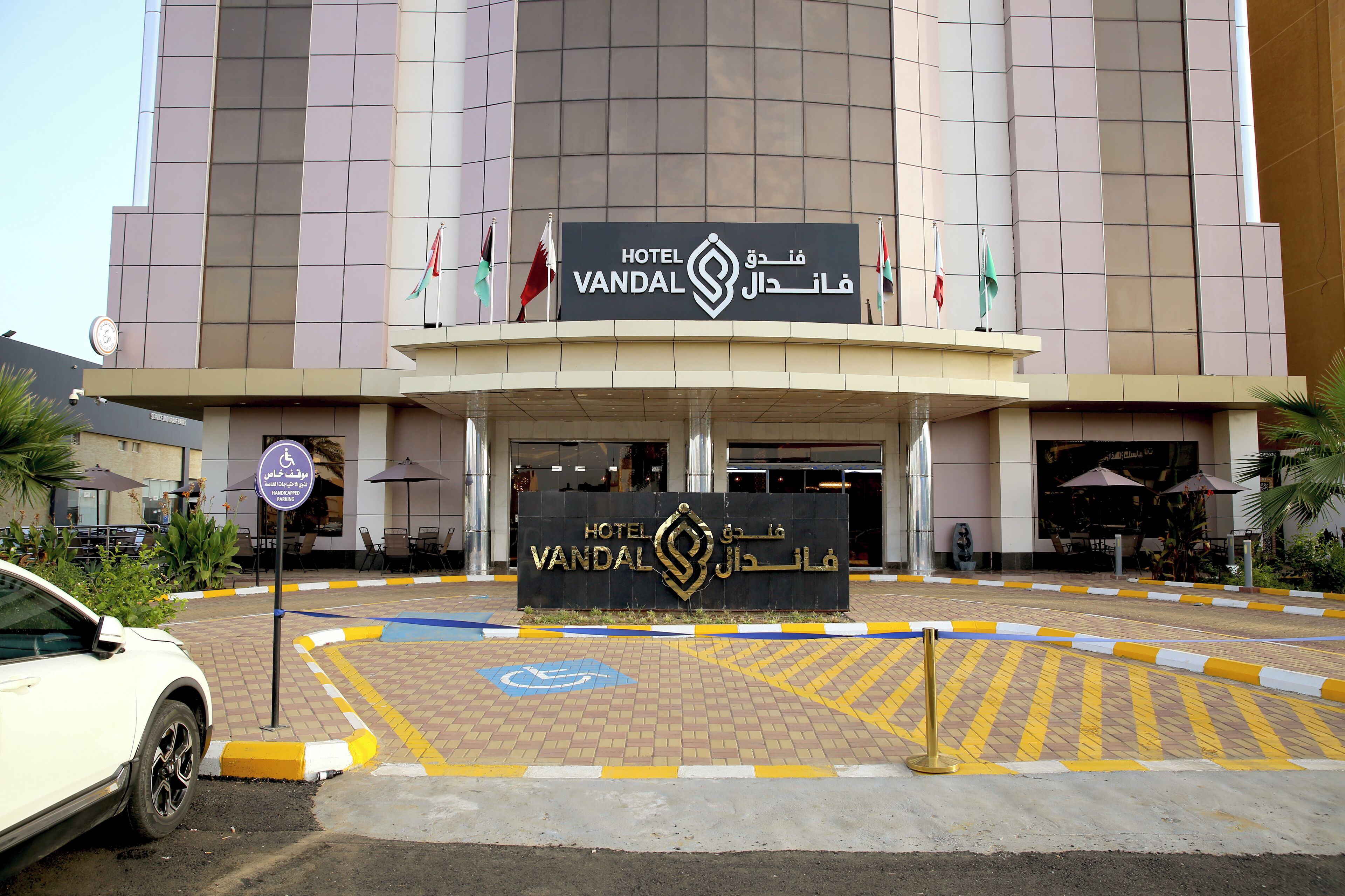 The entrance of Hotel Vandal with a prominent sign and wheelchair accessibility symbol.
