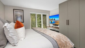 A bedroom with a bed, a television, and a wardrobe. - Steps to Lionshead Gondola in Vail, TT4C (Vail)