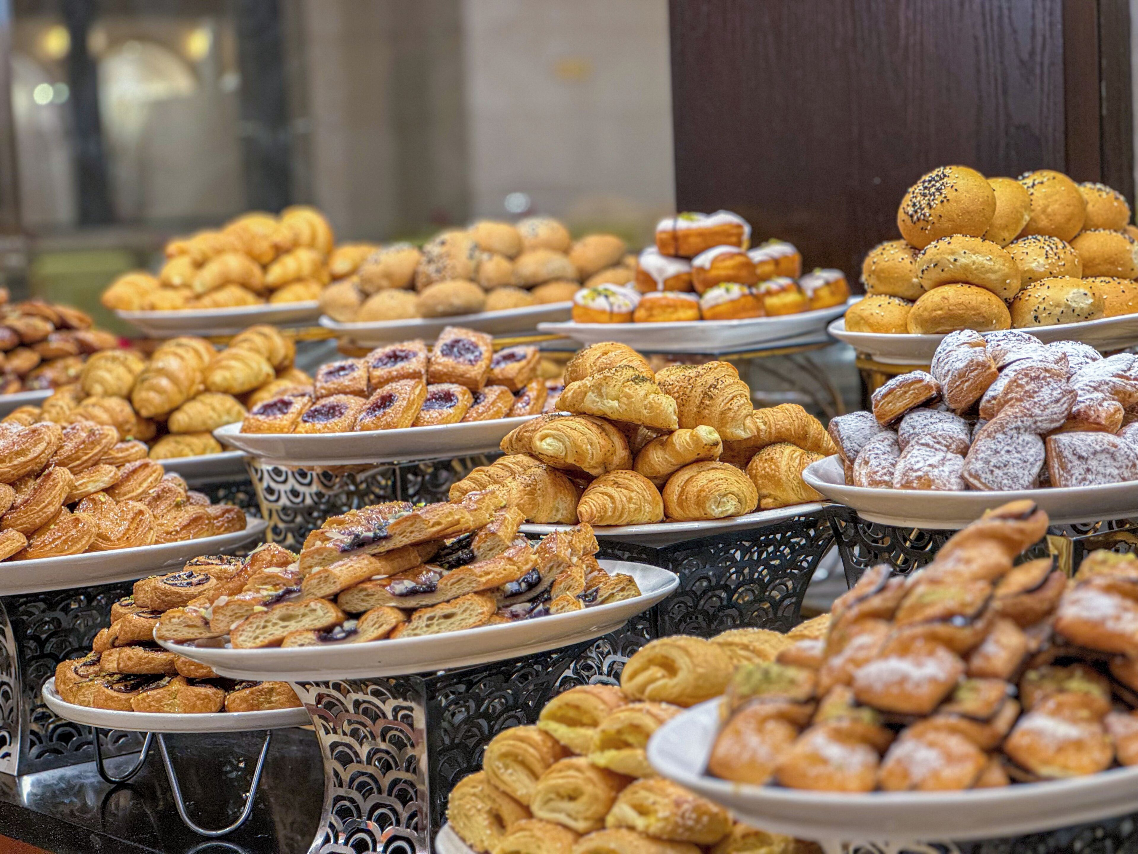 A buffet with various pastries and desserts.