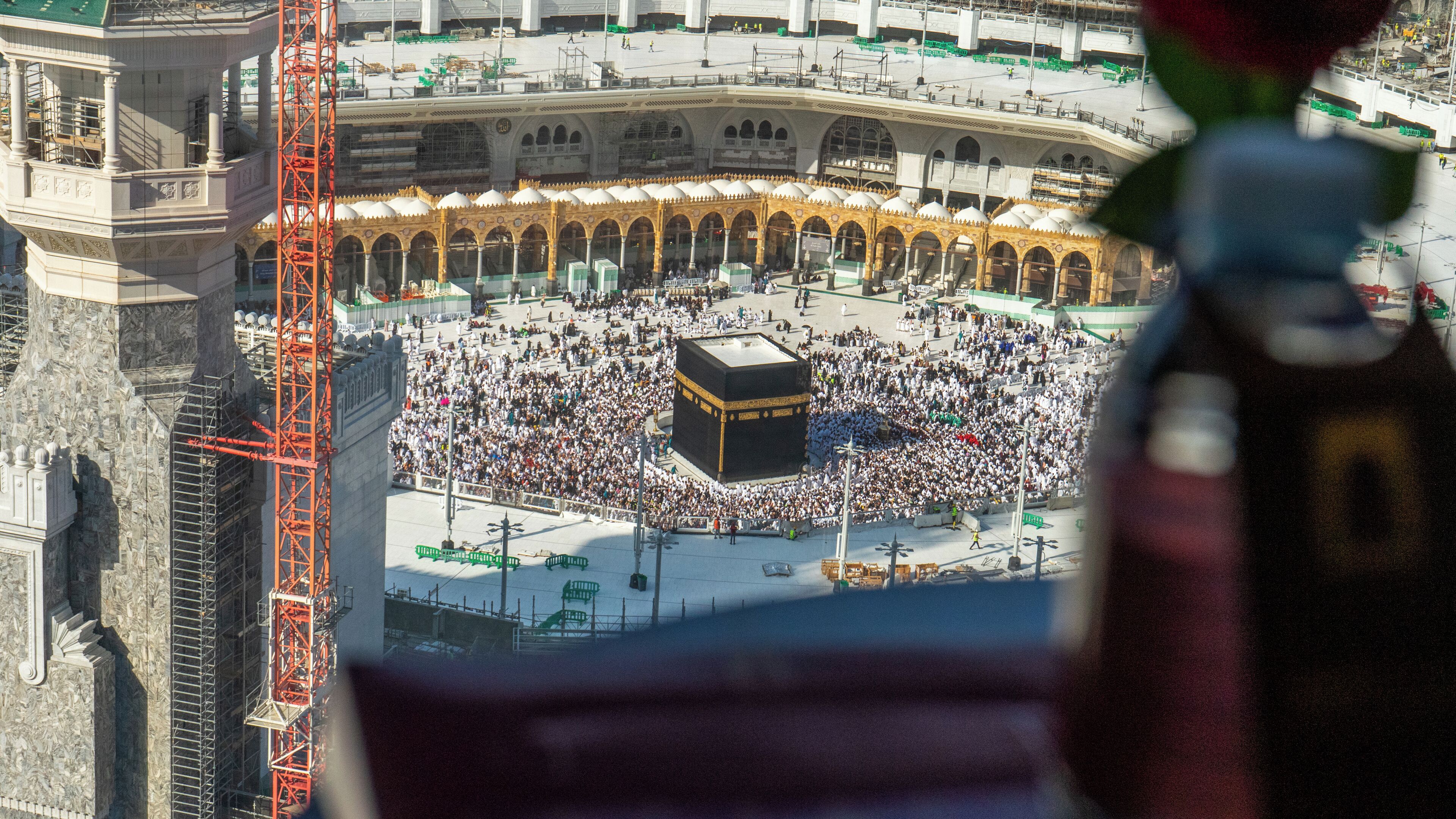 A large open square with a central structure surrounded by a crowd.