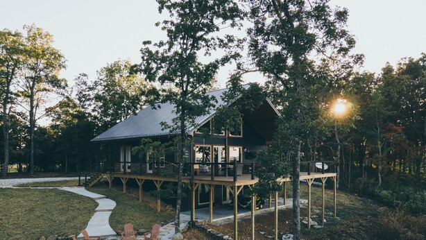 A cabin with a deck, stone fire pit, and outdoor seating. - Experience the most stunning views the Ozarks have to offer (Jasper)