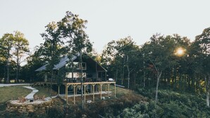 A cabin with a deck, surrounded by dense forest. - Experience the most stunning views the Ozarks have to offer (Jasper)