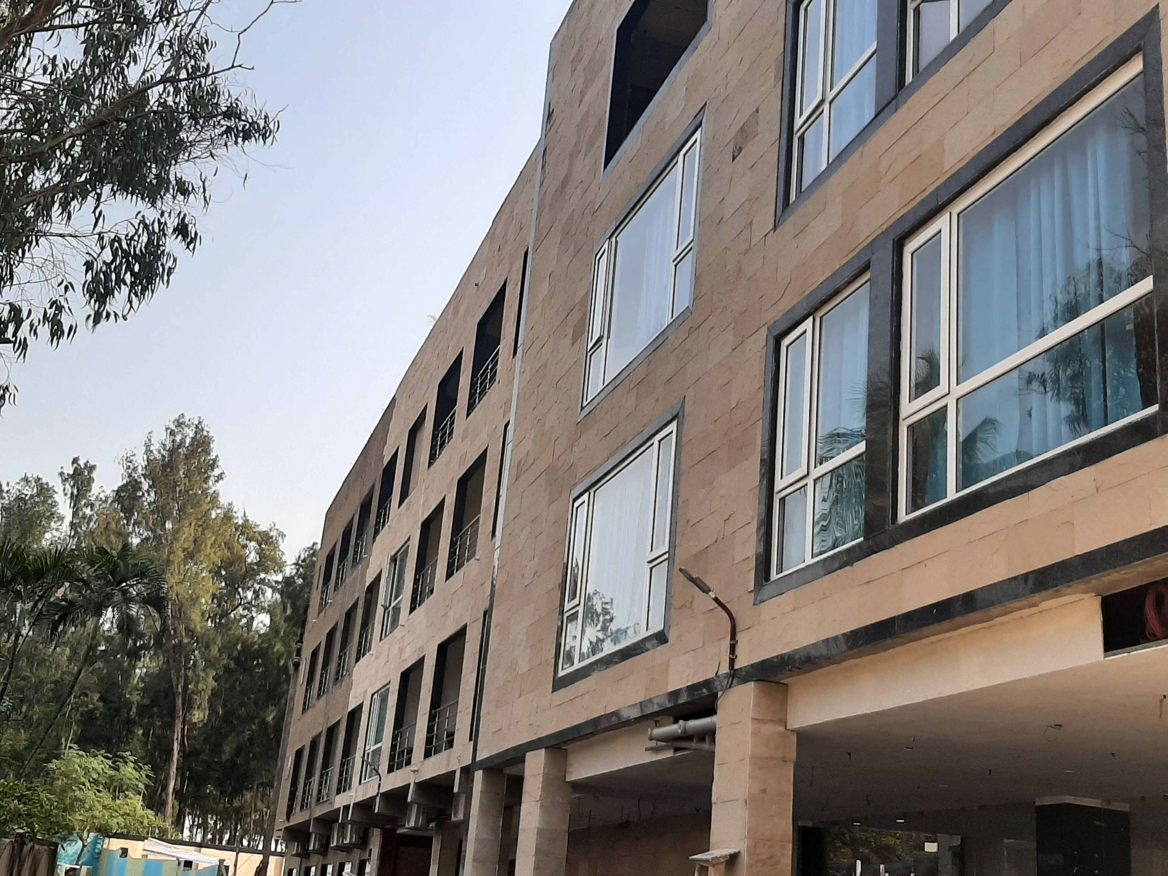 A multi-story building with large windows and balconies.