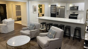 A modern living room with a white sofa, a round coffee table, and a ceiling fan. - Lake front 2.5 miles from Clemson  with private cove  (Central)