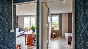 A spacious living area with a dining table, a sofa, and a chair. - Chalet de la Soye (Pierre-Percée)