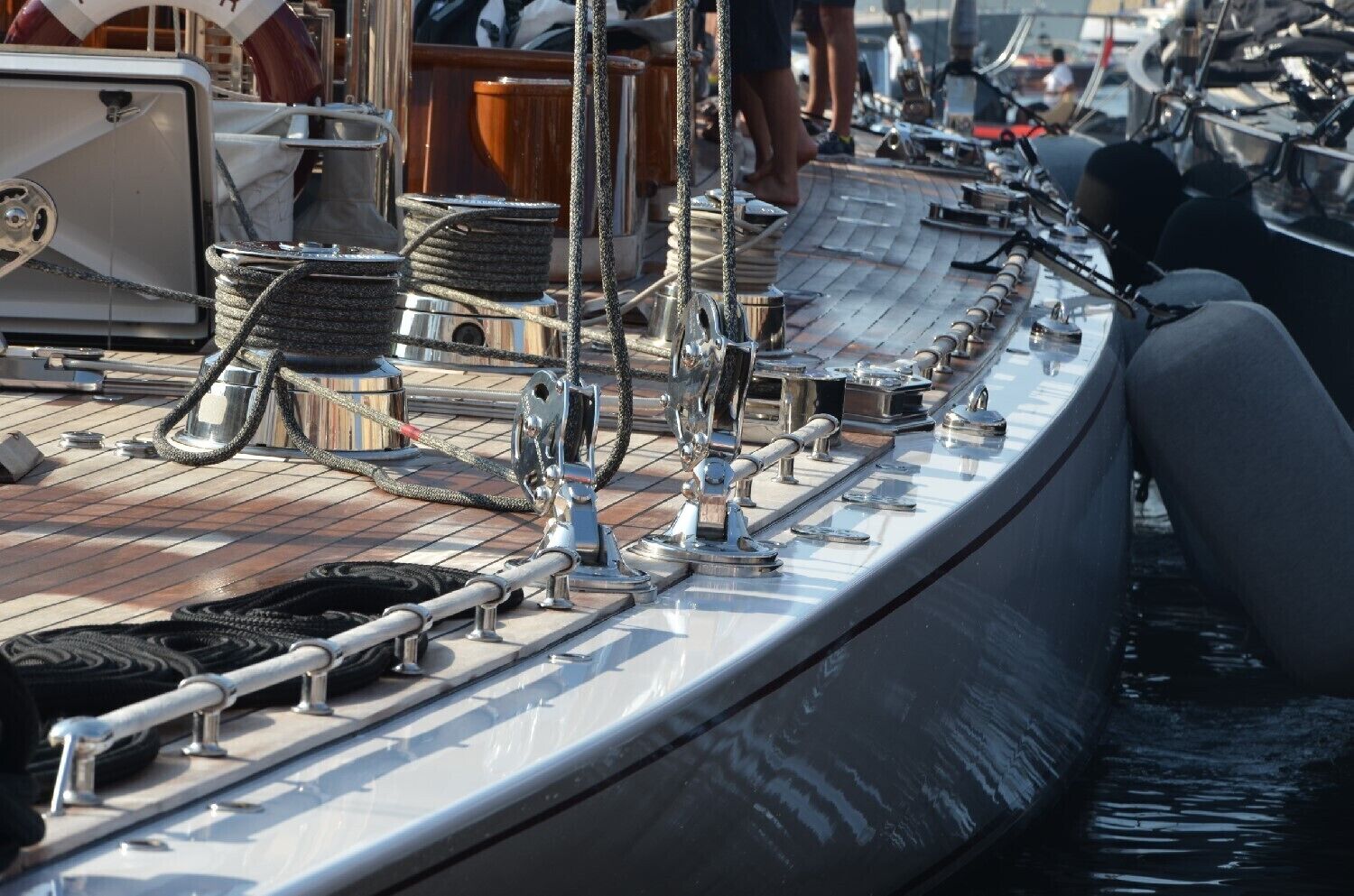 Ein Bootsdeck mit Seilen, Winschen und Metallgeländern.