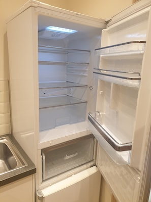 Kitchen features a refrigerator with freezer and water dispenser.