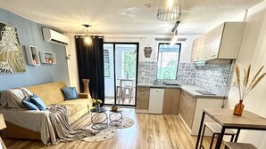 A modern apartment with a living room, dining area, and kitchen. - Studio 5 mn des Plages (Schoelcher)