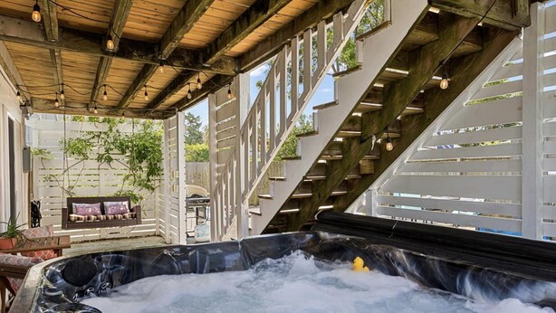 A hot tub area with a wooden ceiling and white railings. - Sea Hag-Heart of Carolina Beach-Private Inground Saltwater Pool (Carolina Beach)