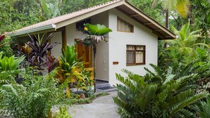A two-story house with a sloped roof, surrounded by lush tropical vegetation. - LA PONDEROSA Beach & Jungle Resort (Pavón)