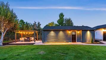 Enjoy the serene atmosphere of this beautifully maintained home with a patio and outdoor seating area.