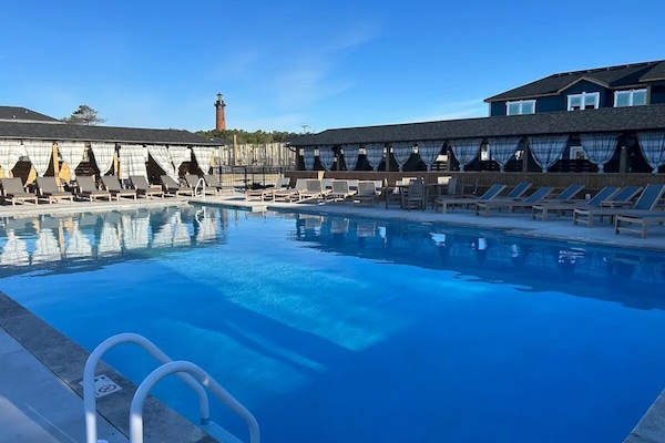 Heated saltwater community pool with resort pool cabanas to rent.
