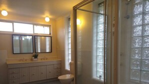A bathroom with a toilet, a sink, a mirror, and a shower area. - Happy & Spacious Home (nr hospital) @Garran (Garran)