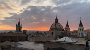 A cityscape with historic buildings and a dome structure, viewed from a rooftop. - Families, groups of friends, looking for a comfortable apartment in the Acese Baroque (Acireale)