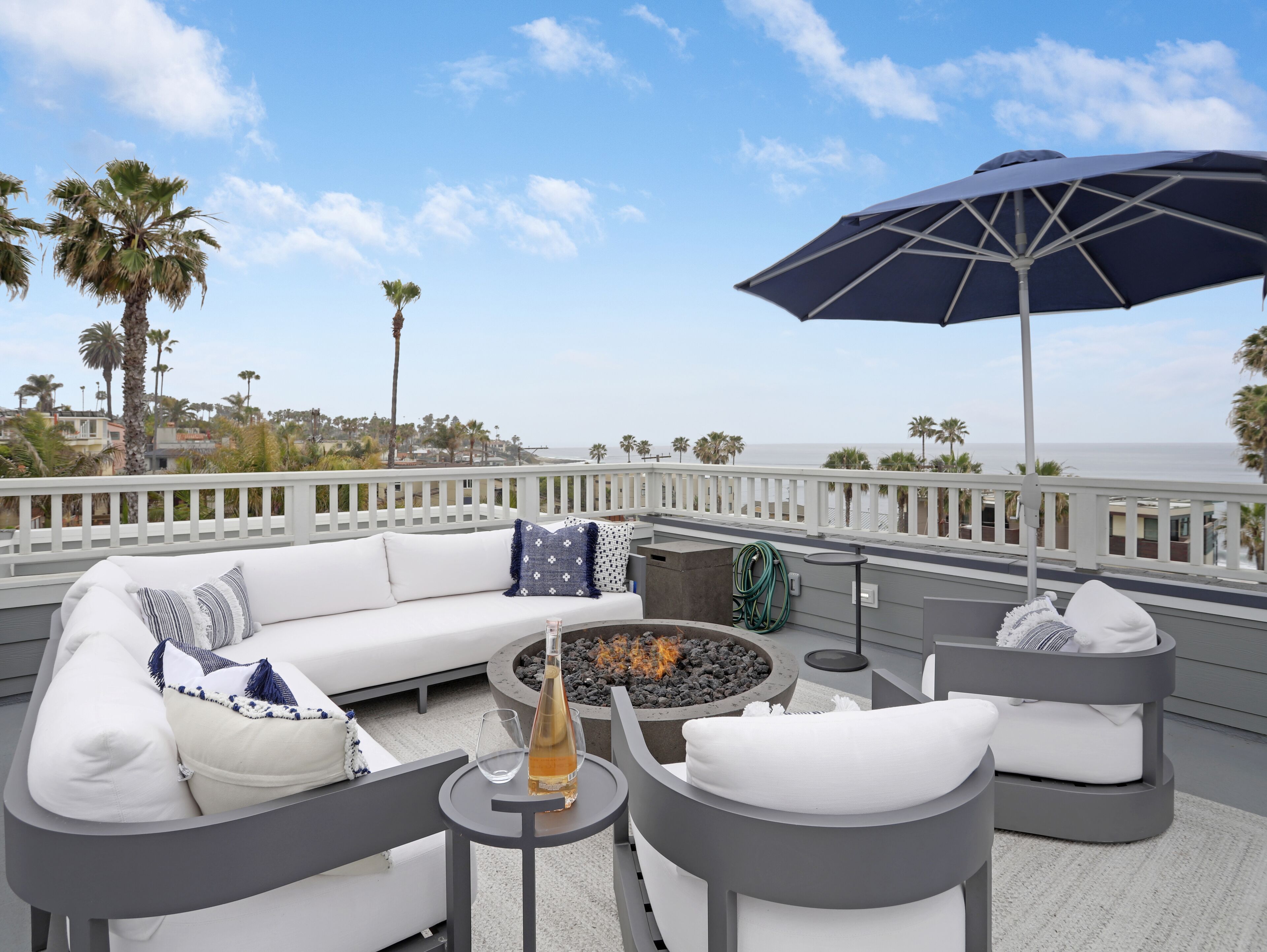 Designer luxury coastal home w/ panoramic ocean views, rooftop deck, & fire pit